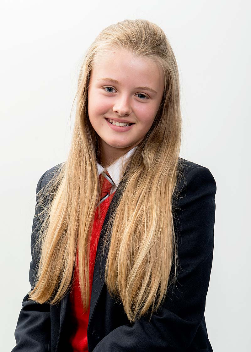 student sits for portrait